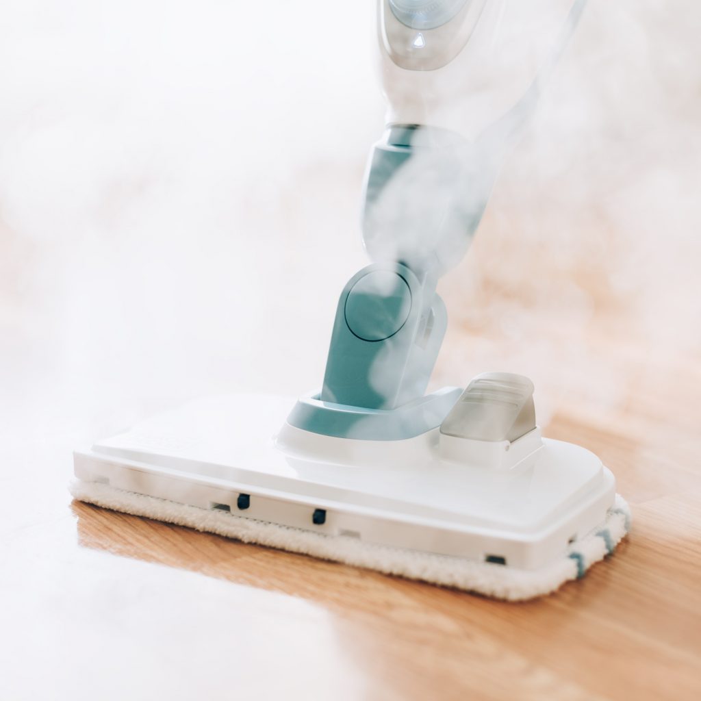 Cleaning the floor with steam cleaner. Banner and copy space. Cleaning service concept